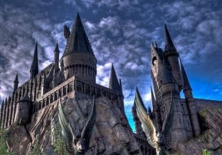 Perched atop a rugged cliff, the majestic Hogwarts Castle stands tall under a dramatic sky