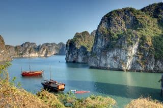 Traditional Junks Amidst Halong Bay's Emerald Waters