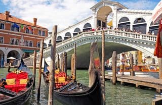 Gondolas moored at the Rialto Bridge in Venice, Italy