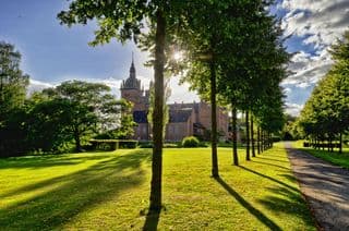 Sunlit Pathway to Vallø Castle in Denmark