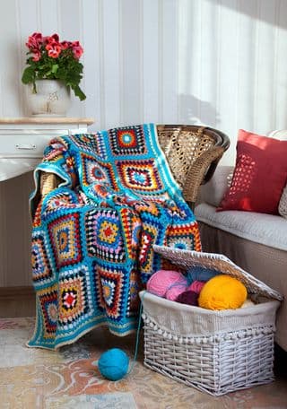 Handmade Crochet Throw Blanket on a Rattan Armchair