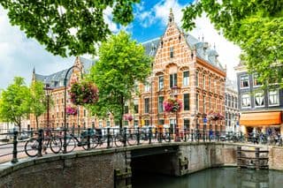 Historic Amsterdam Bridge Over Canalside