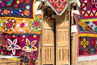 Vibrant Uzbek Textiles Adorning Wooden Doors