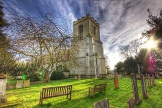 Ancient Church Tower Amidst Cemetery