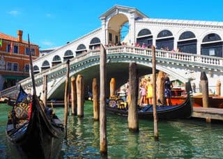 Gondolas moored at the historic Rialto Bridge