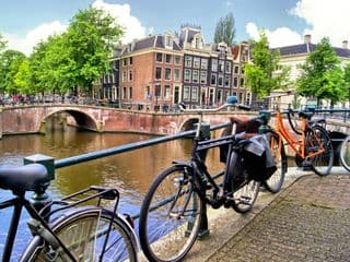 Bicycles Resting by an Amsterdam Canal