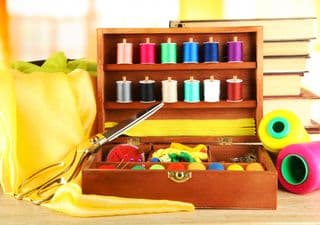 Colorful Thread Spools in a Wooden Box