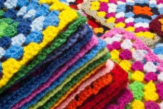 Stack of Vibrant Crocheted Granny Squares