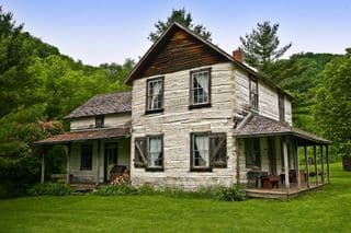 Weathered Log Cabin Nestled in the Forest