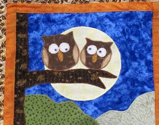 Owls Perched Under the Full Moon