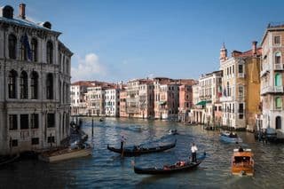 Gondolas glide through the Grand Canal in Venice